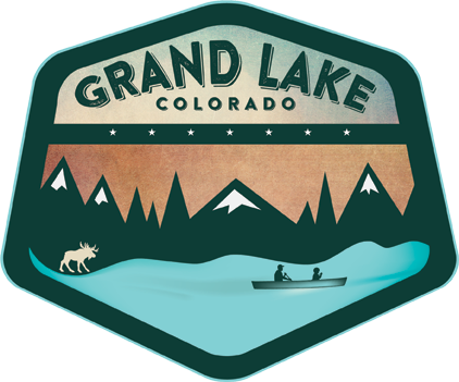 A patch of grand lake, colorado with mountains and a boat.