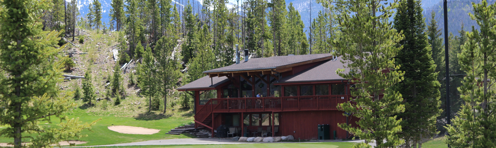 A large red house with a balcony and a porch.