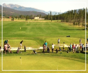 A group of people standing on top of a green.