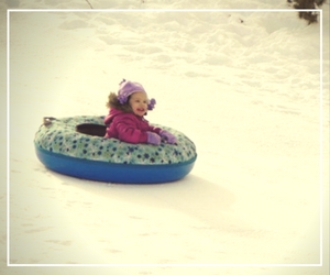 A child is riding in an inflatable boat.