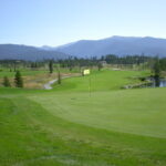 A golf course with mountains in the background.