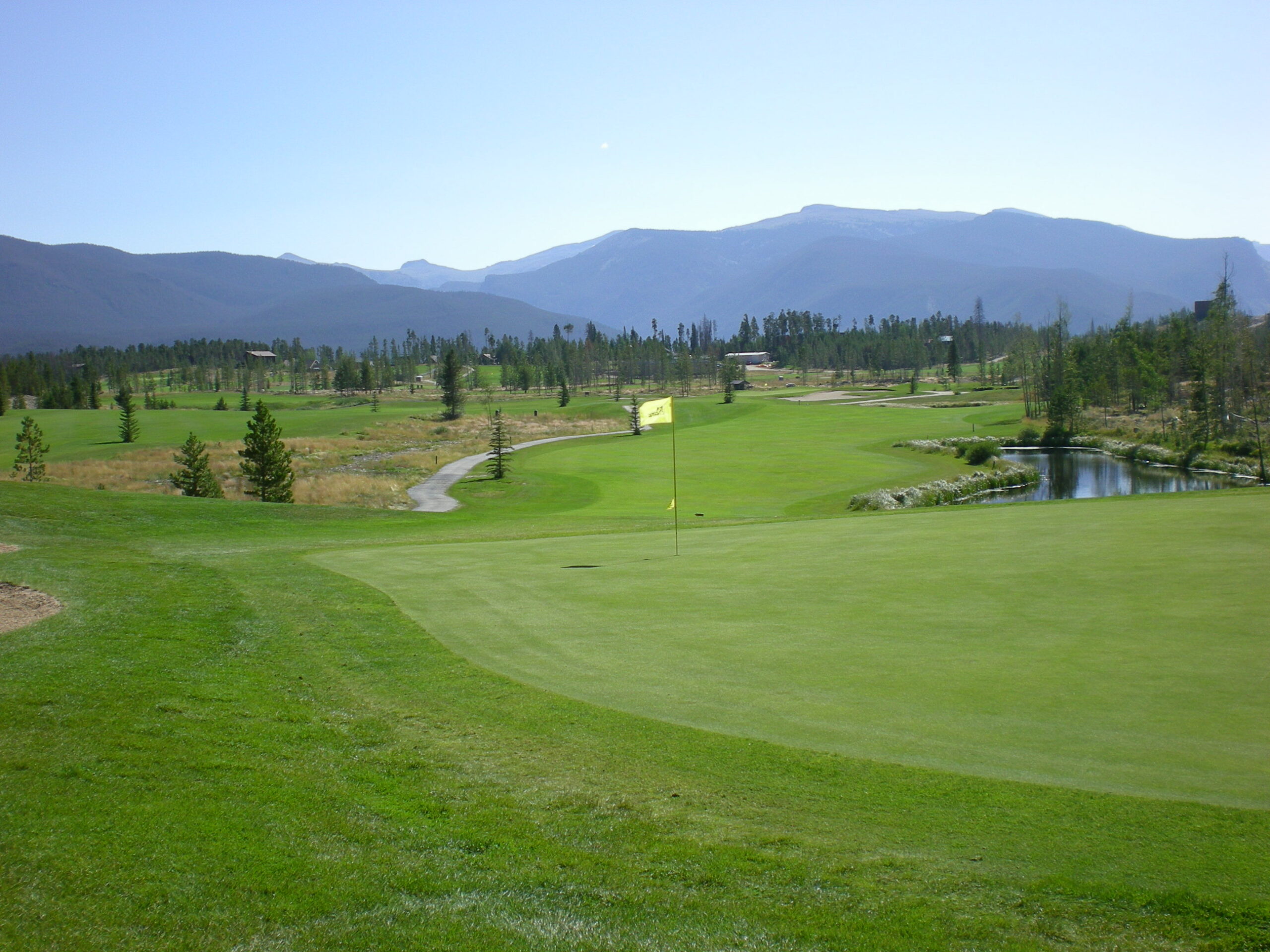 A golf course with mountains in the background.